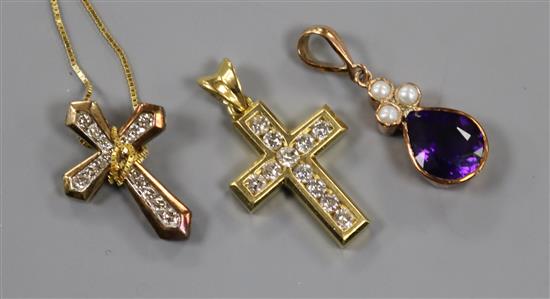 An 18ct gold and diamond cross pendant, one other diamond cross pendant on 14k chain and a 9ct gold gem set pendant.